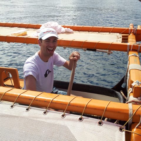 a person sitting on a canoe in a body of water