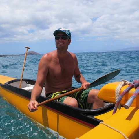 a man riding on the back of a boat