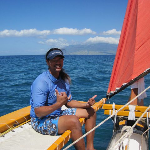 a person sitting in a boat on a body of water