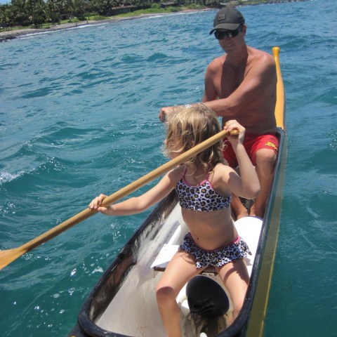 a person riding on the back of a boat in the water