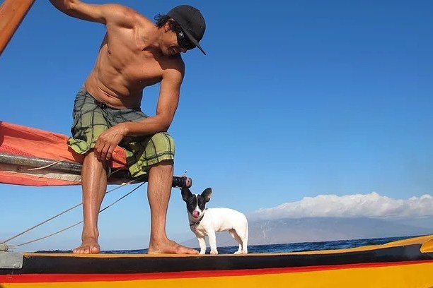 a man riding on the back of a boat