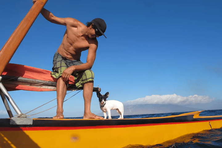 a man sitting in a boat on a body of water