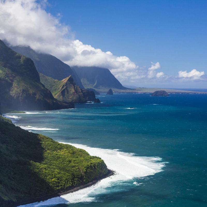 a body of water with a mountain in the background