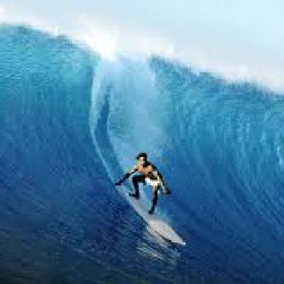 a man riding a wave on a surfboard in the ocean